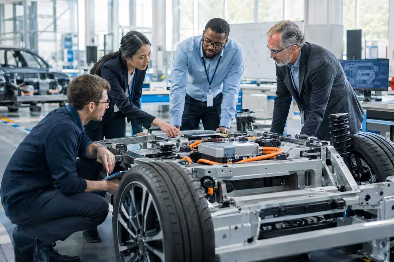 Consultants and engineers reviewing an automotive prototype.