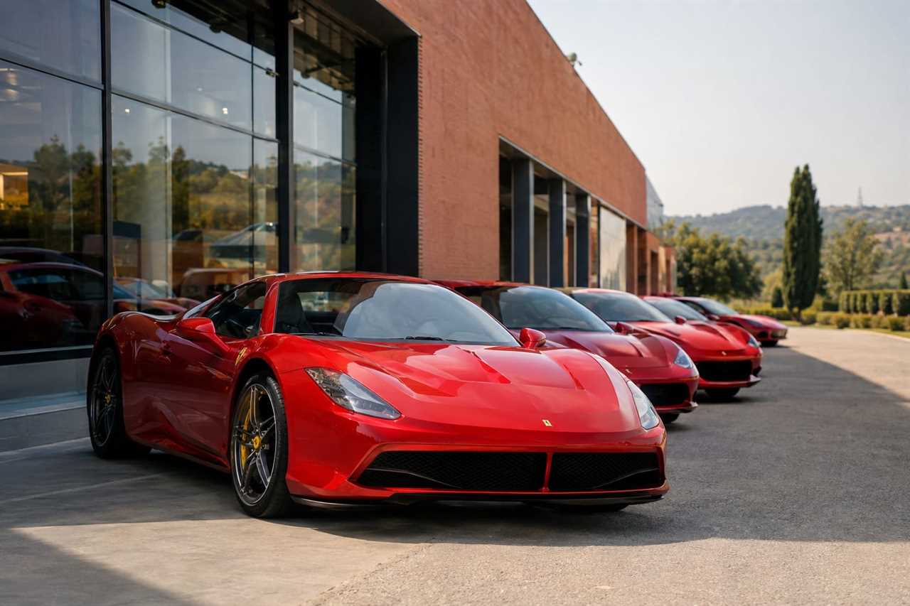 Luxury sports cars displayed outside a factory showroom