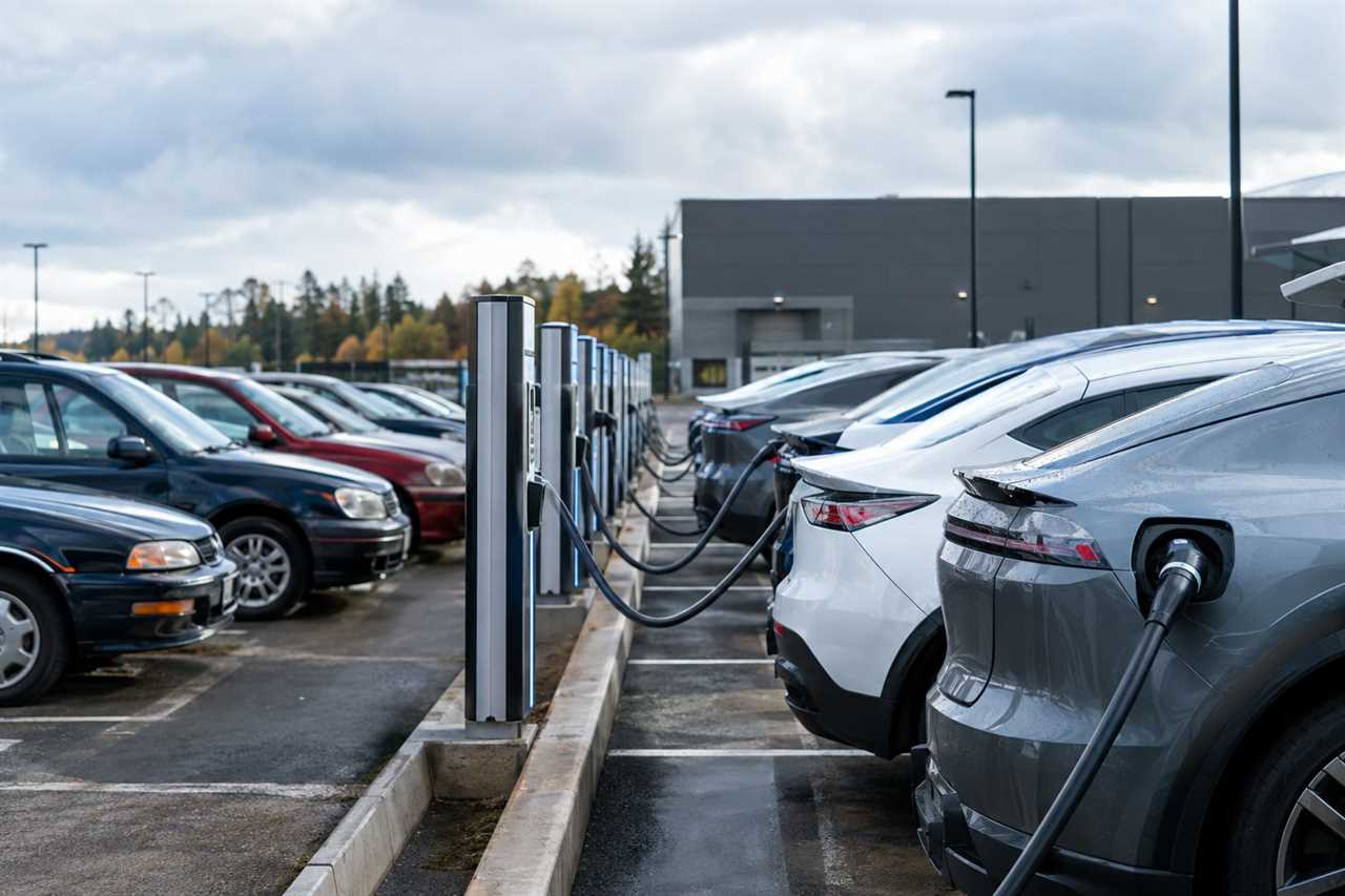 Electric vehicles charging near older gas cars