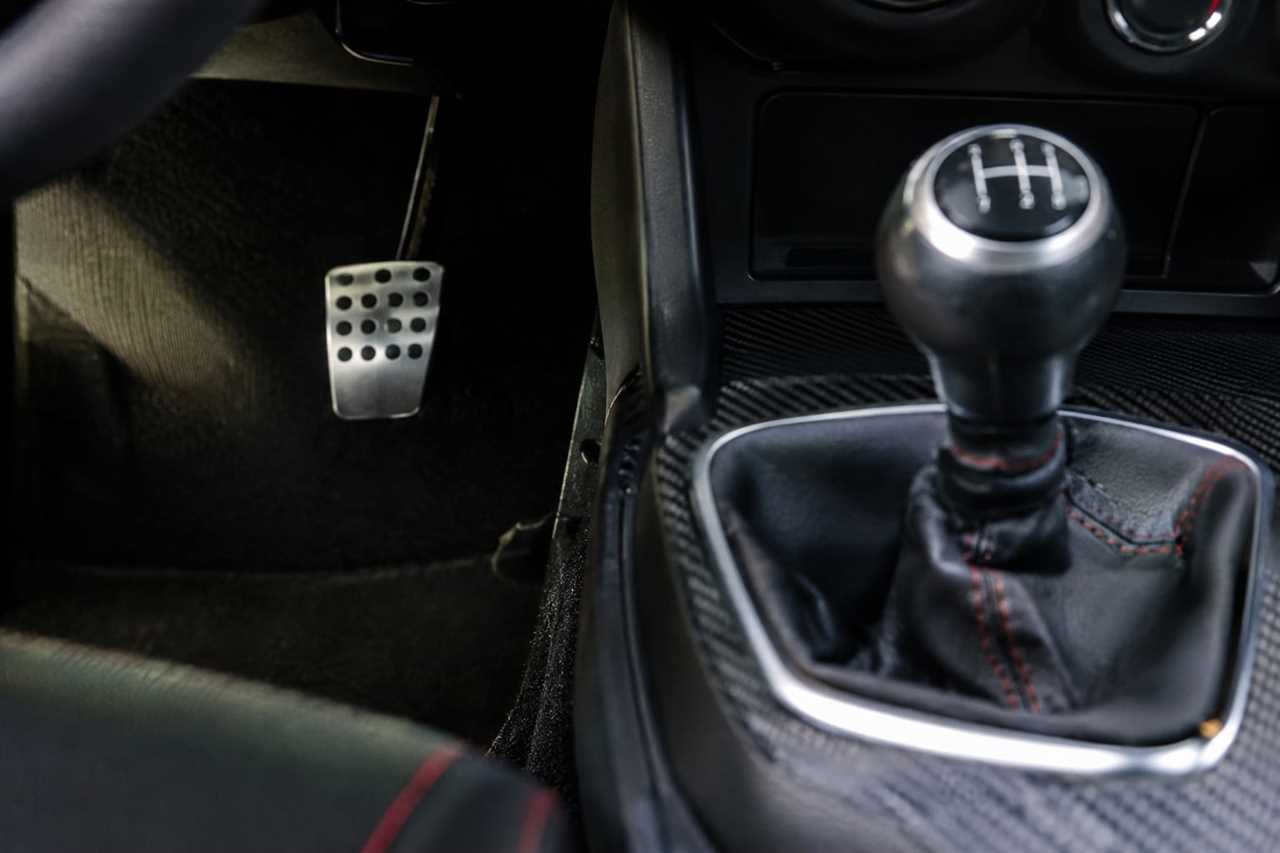 Traditional shifter and clutch pedal inside a sports car