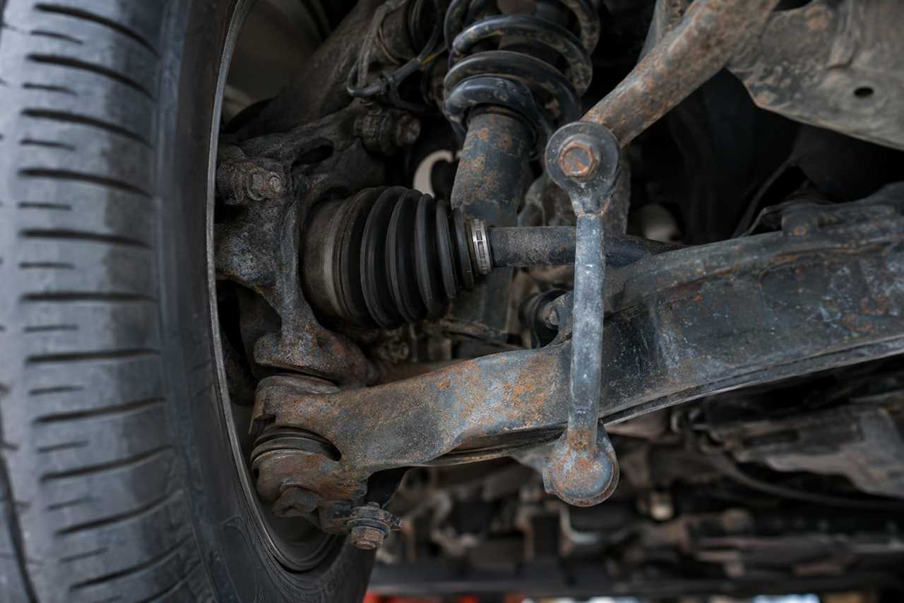 Close-up of corroded metal bolt on vehicle underside.