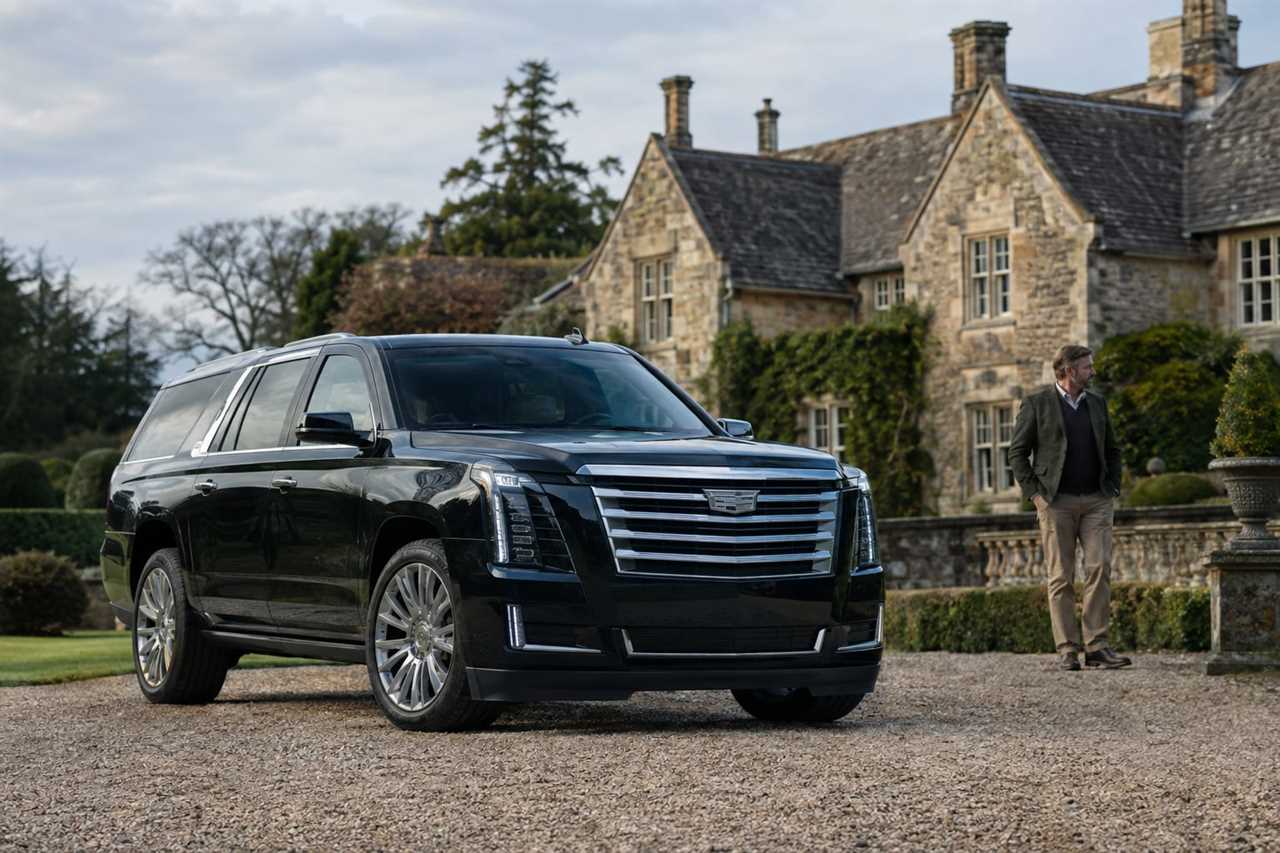 Large luxury SUV parked before a stately countryside home
