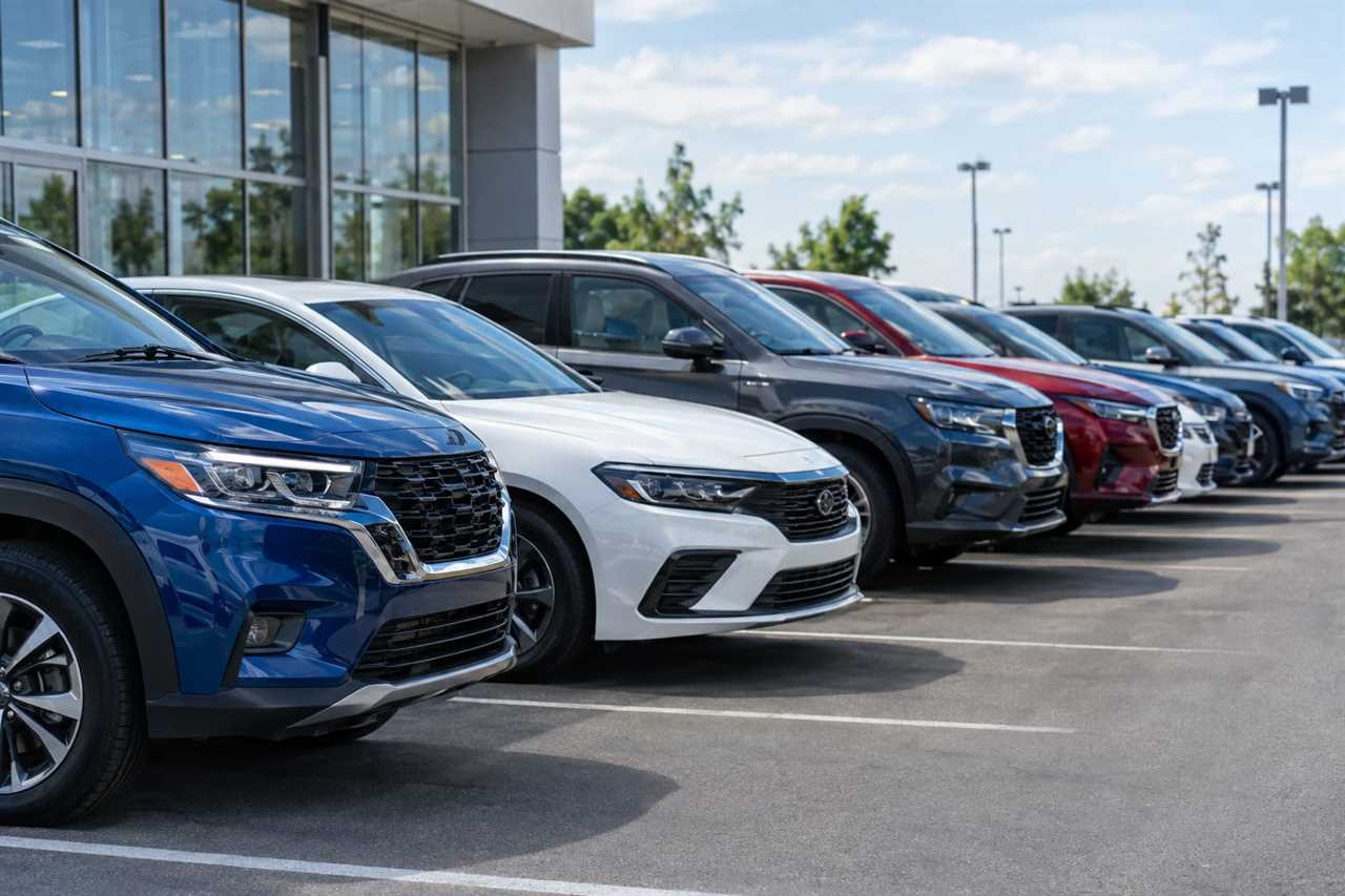 New cars lined up on a dealership forecourt