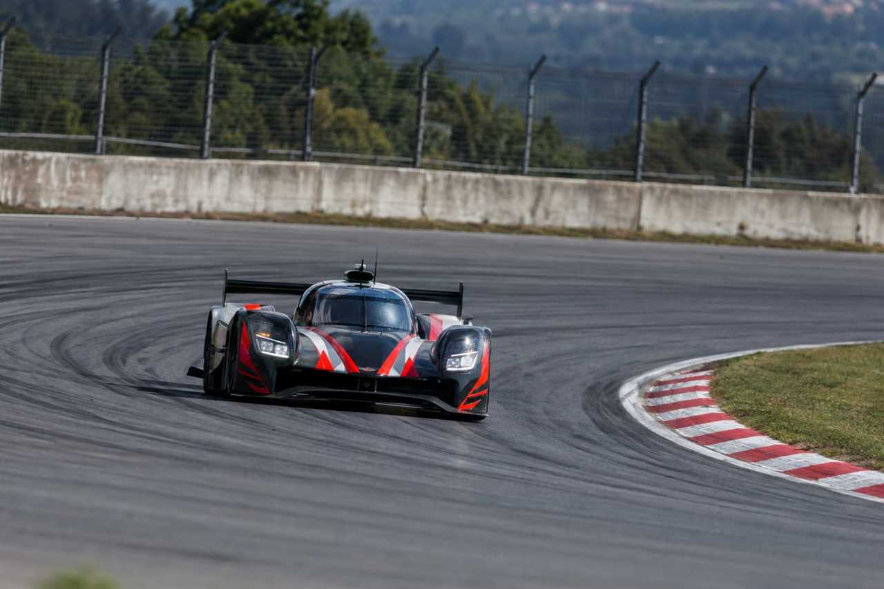 Prototype race car powers through a racetrack corner