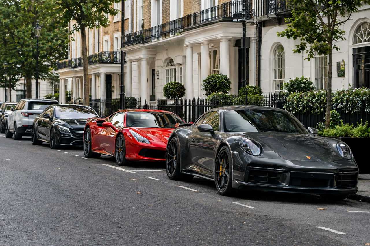 Luxury cars parked on an affluent city street