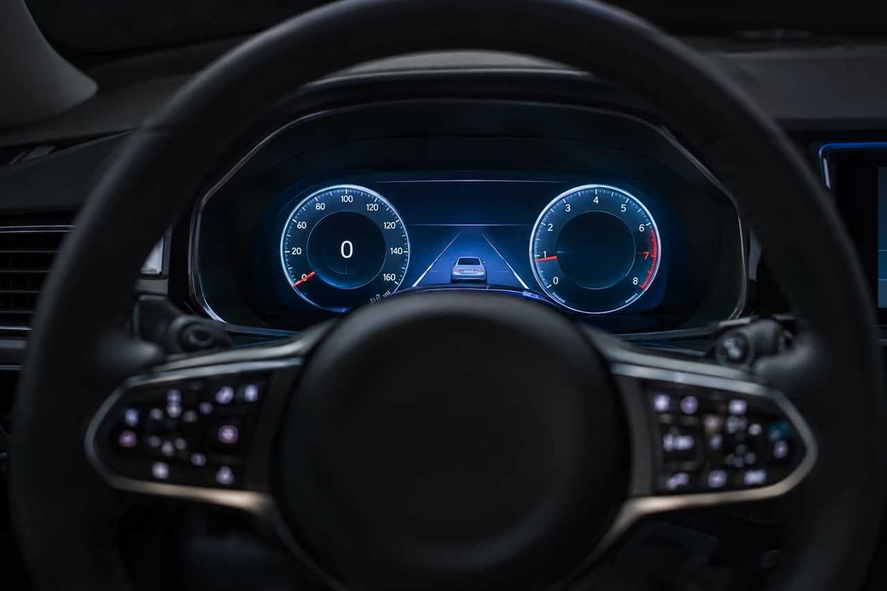 Digital instrument cluster glowing behind a steering wheel