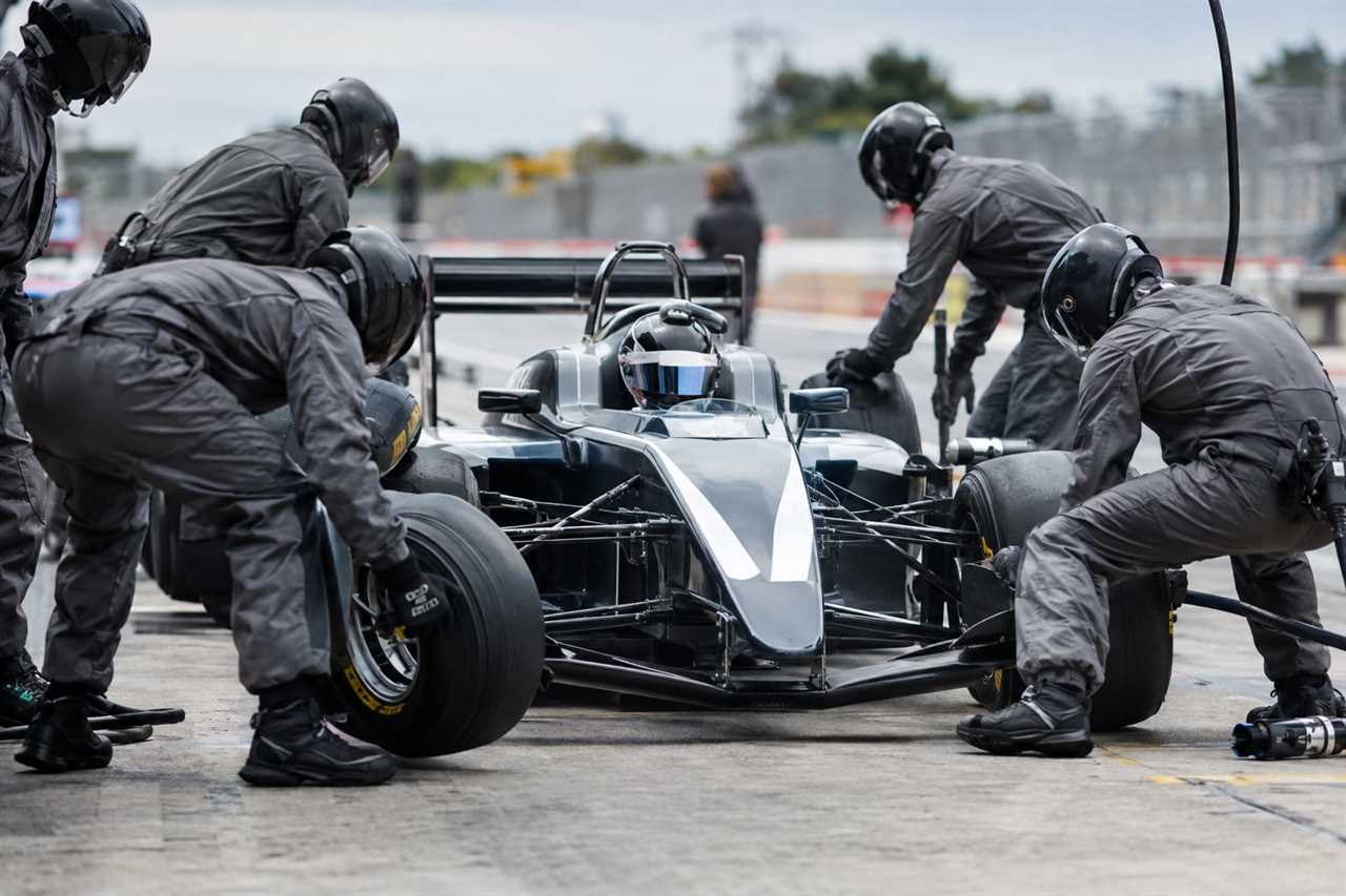 Pit crew executes a rapid tyre change
