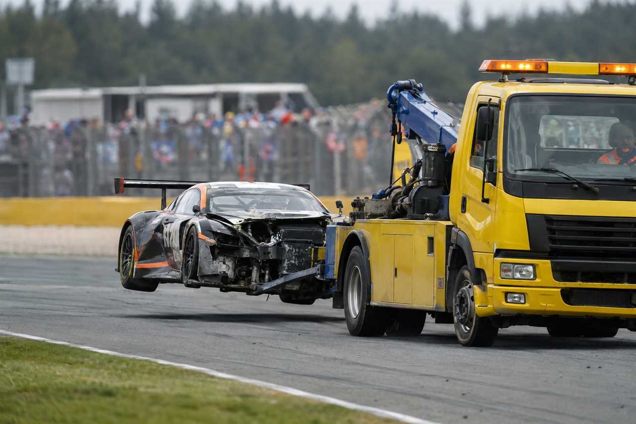 Crew recovers a car during caution period