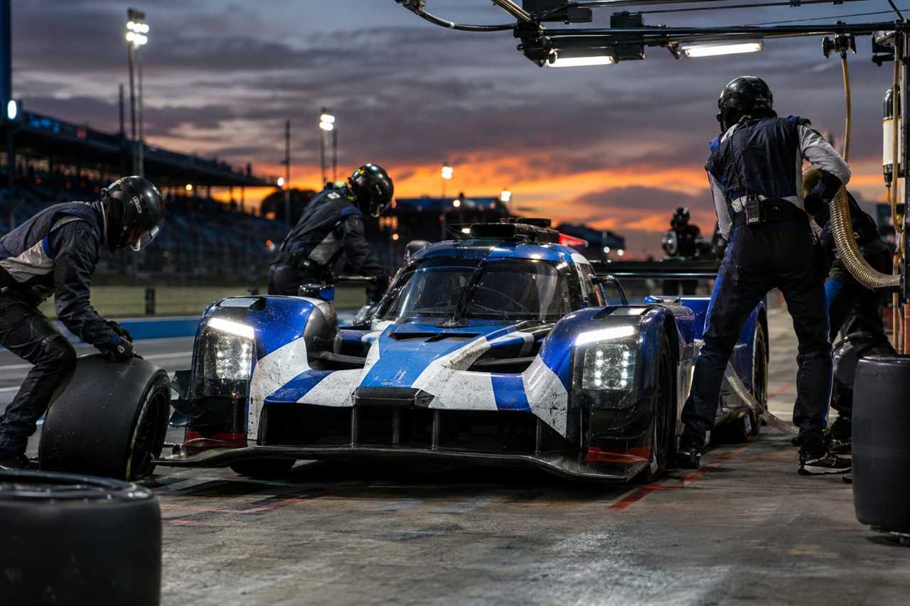 Race team performs a late pit stop for tires and fuel.
