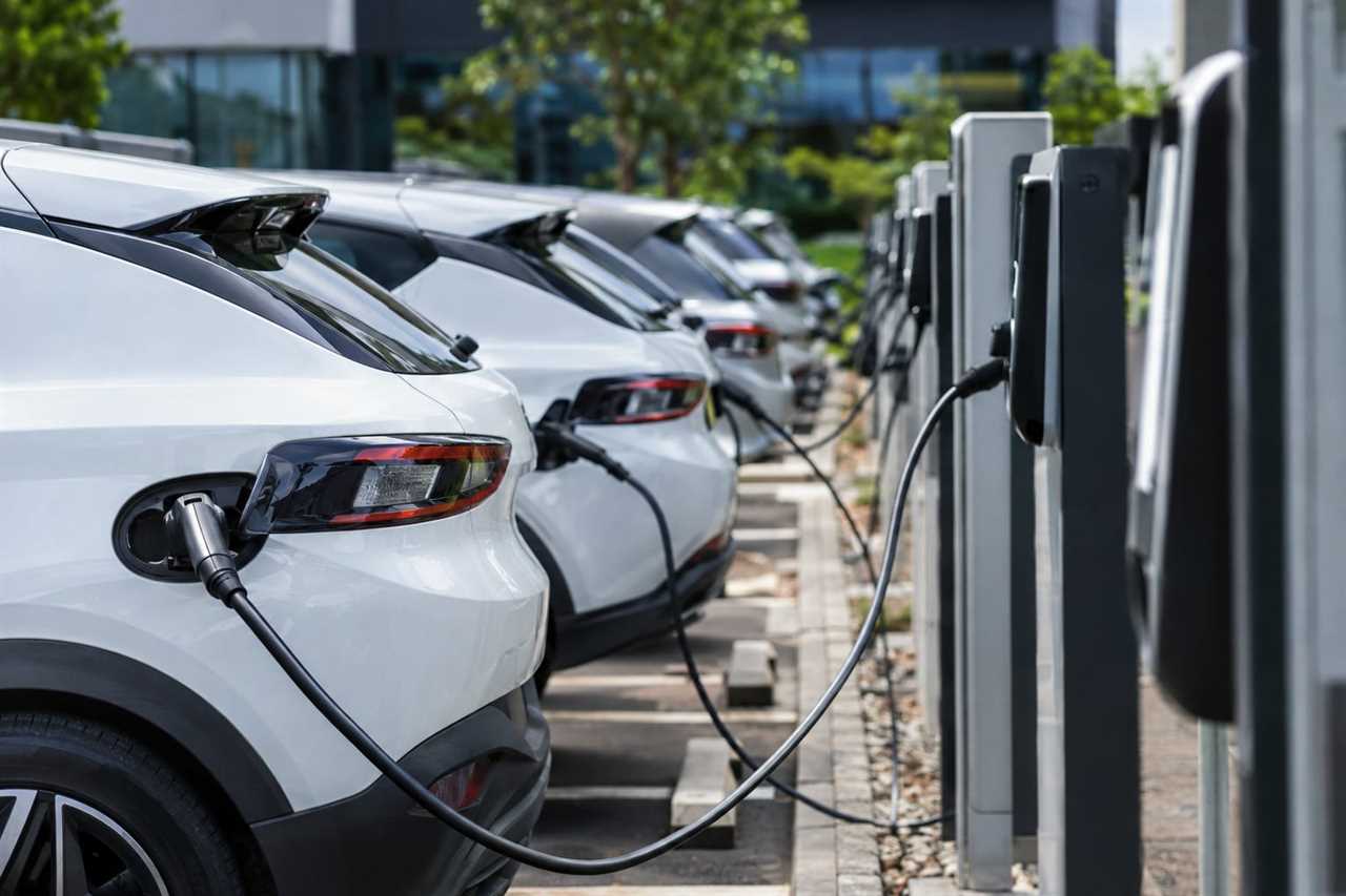 Electric company cars charge in a business fleet car park