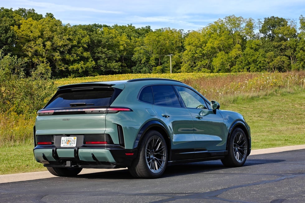 Stylish SUV parked in a scenic landscape with trees and a field in the background.