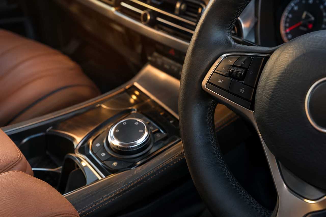 Upscale cabin with leather trim and physical controls.