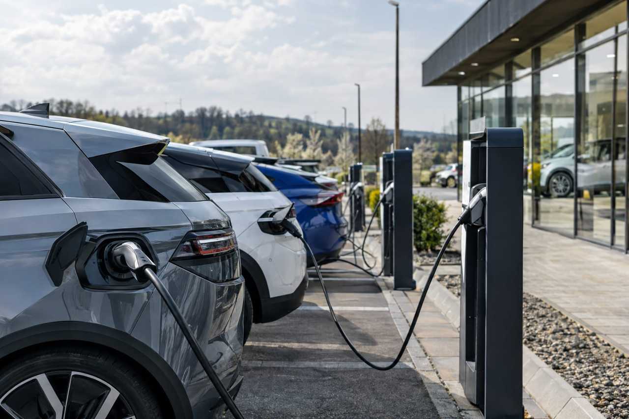Electric vehicles charging at European dealership.