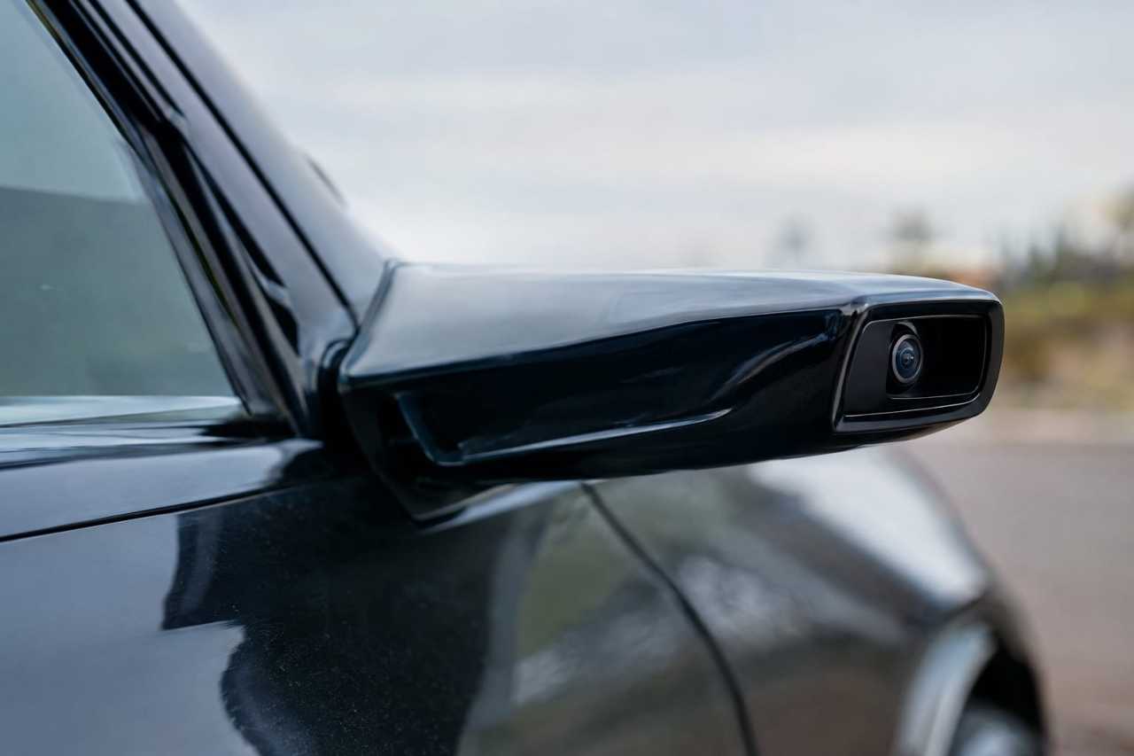 Camera-based side mirror replaces traditional glass mirror.